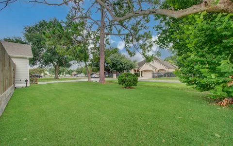 a view of green field with house in the background
