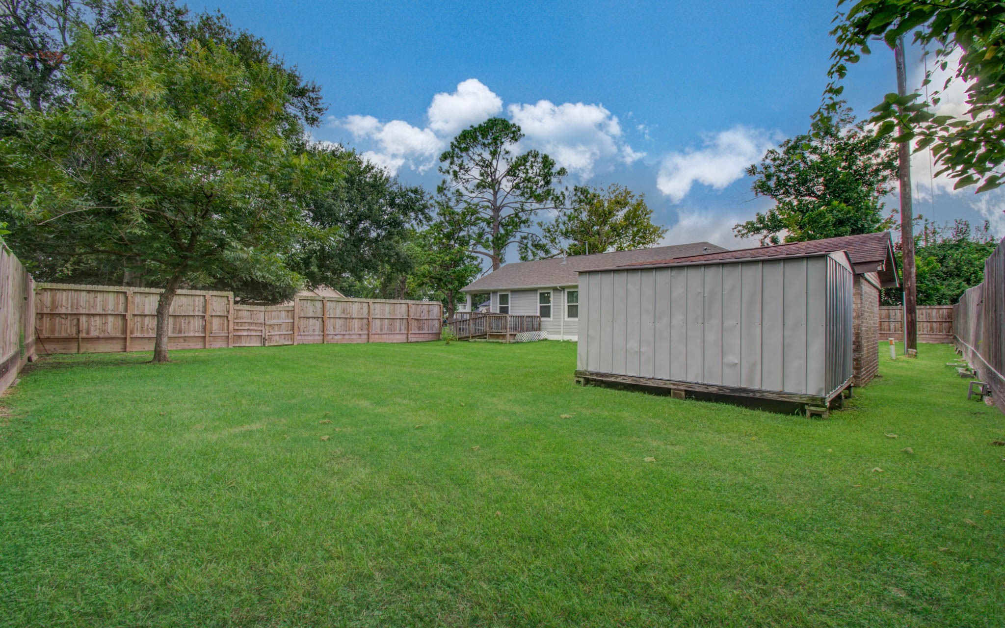 2722 Vega Houston, TX 77088 - Photo 41 of 45 a view of a backyard with a cabin and wooden fence