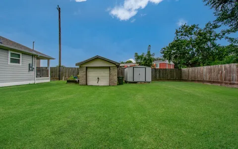 an aerial view of a house with a yard and swimming pool