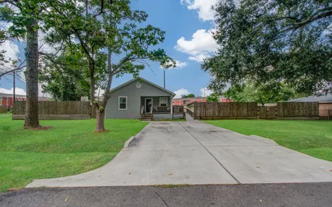 a front view of house with a garden