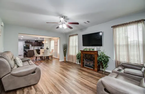 a living room with furniture and a flat screen tv
