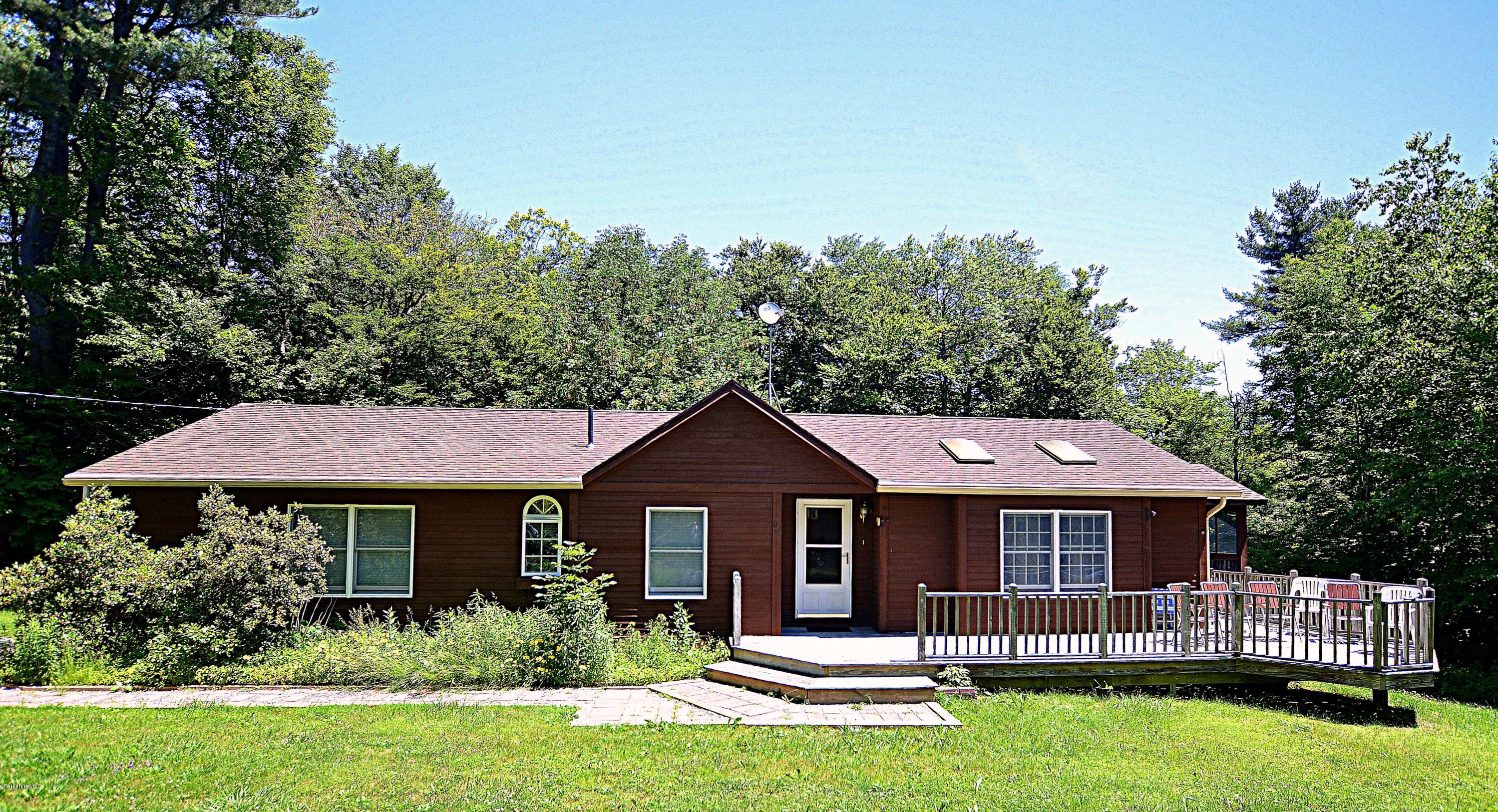 982 Fred Snow Road Becket, MA 01223 - Photo 2 of 21 a front view of a house with a garden