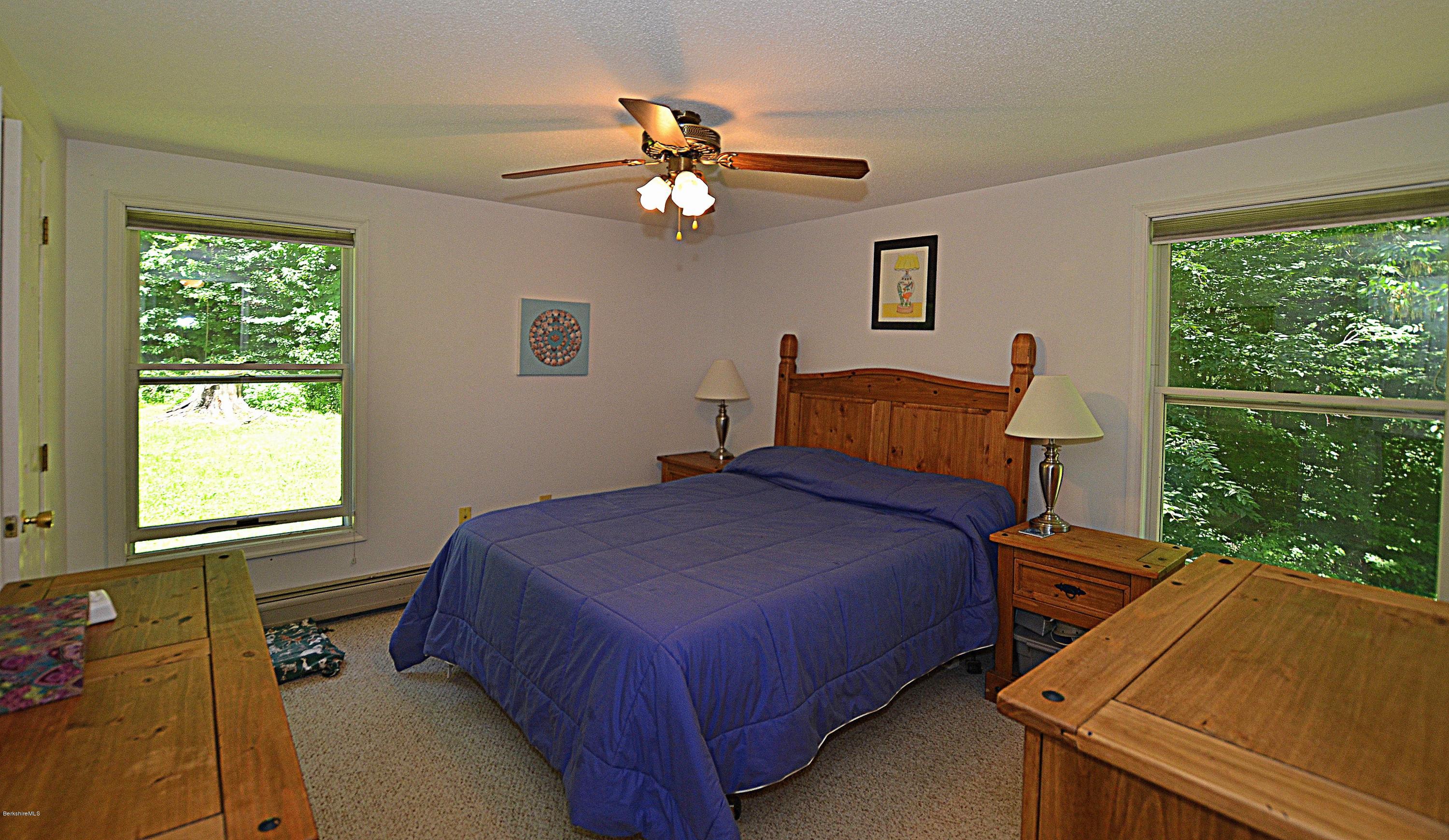 982 Fred Snow Road Becket, MA 01223 - Photo 12 of 21 a bedroom with a bed and a window