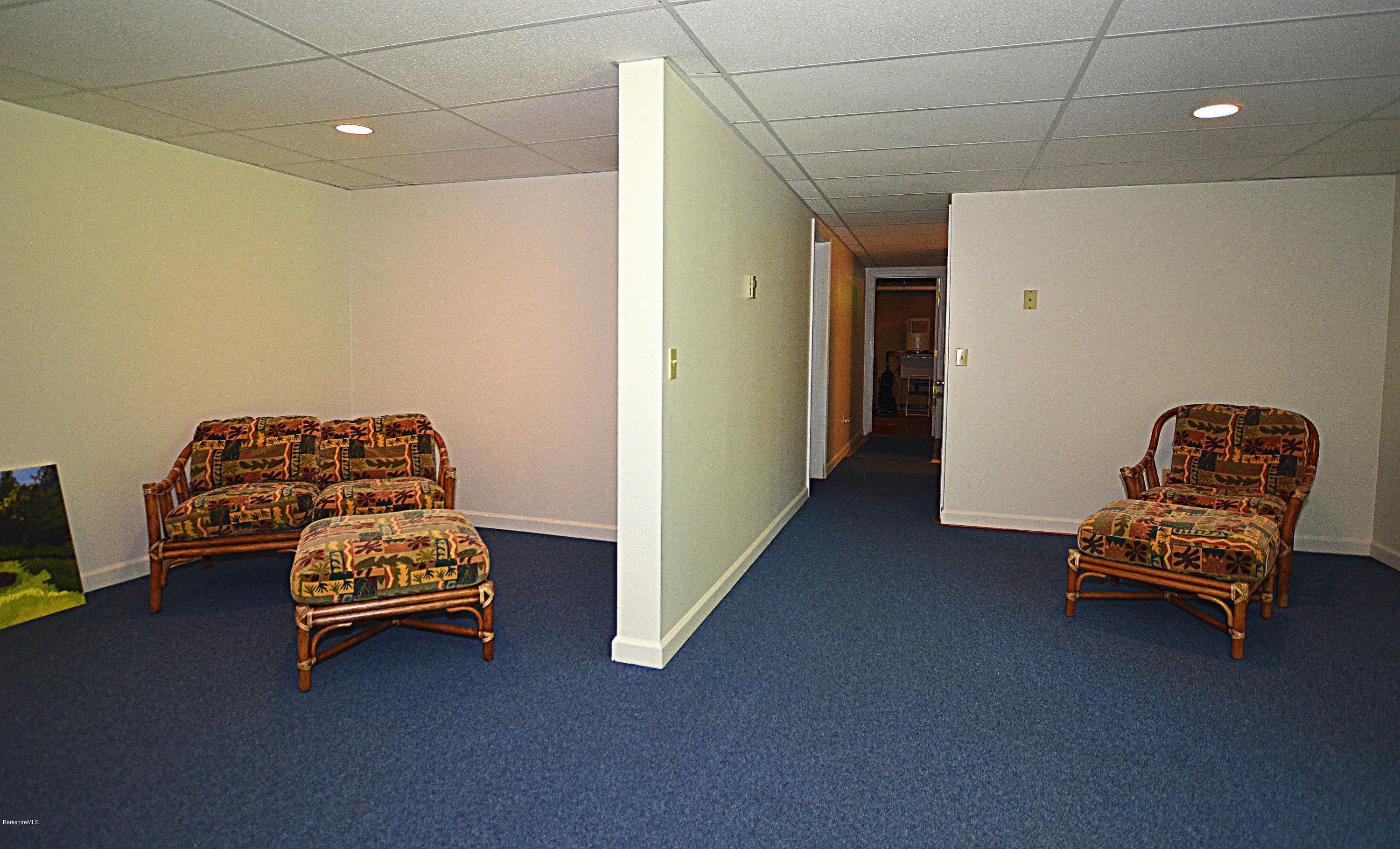 982 Fred Snow Road Becket, MA 01223 - Photo 16 of 21 a room with a baby crib furniture and a chandelier