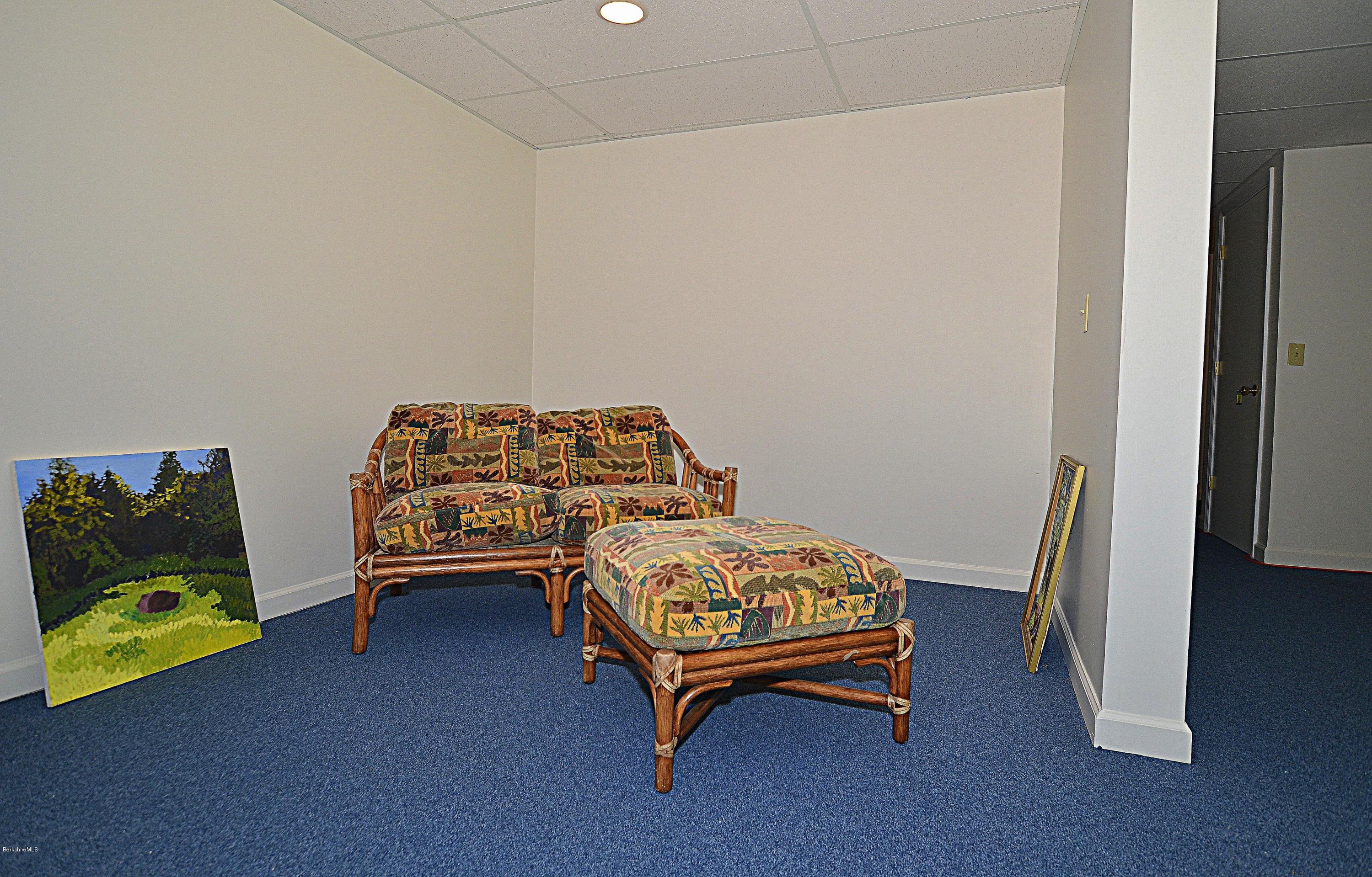 982 Fred Snow Road Becket, MA 01223 - Photo 18 of 21 a bedroom with a bed and a couch
