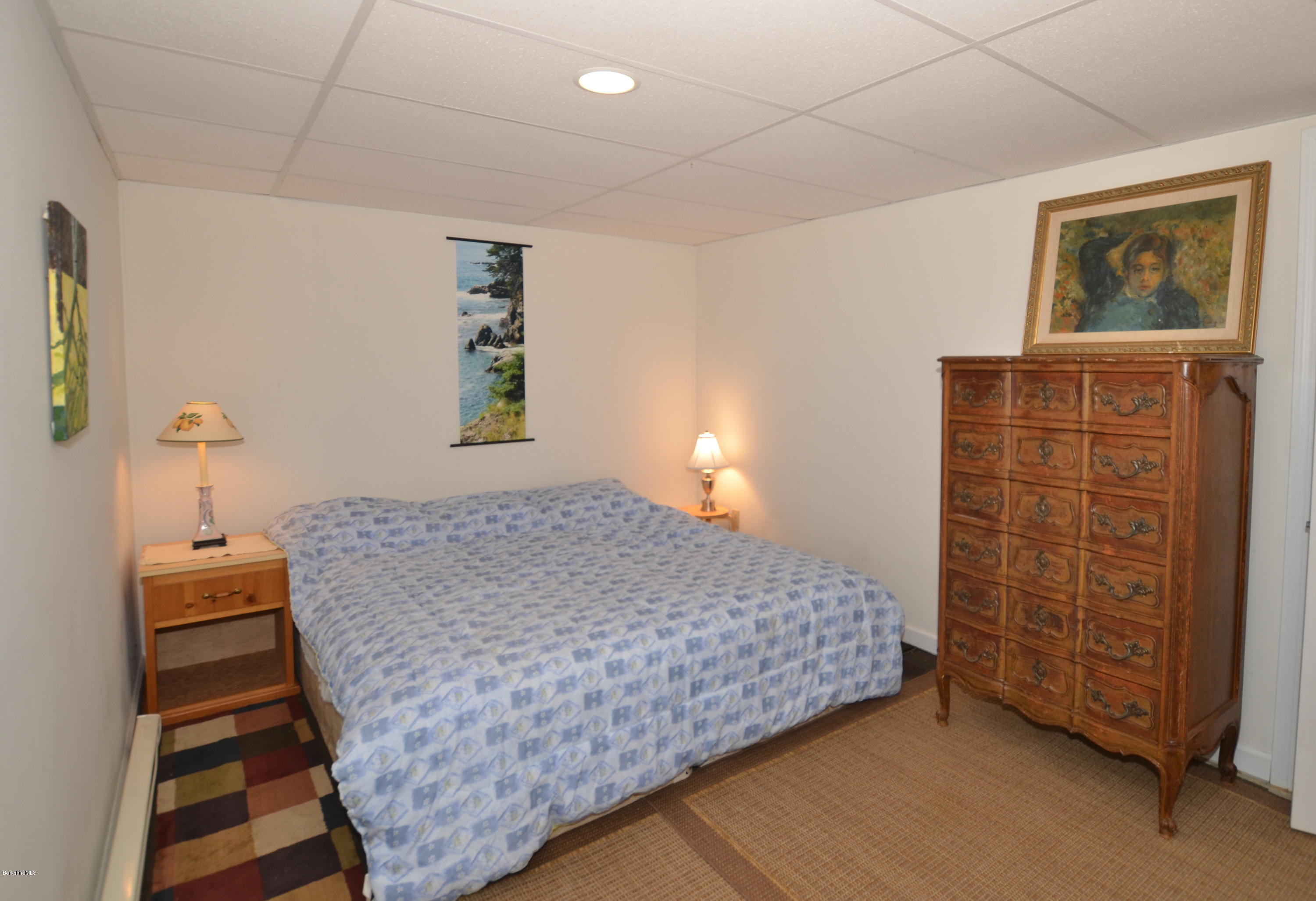 982 Fred Snow Road Becket, MA 01223 - Photo 20 of 21 a bedroom with a bed and a cabinets