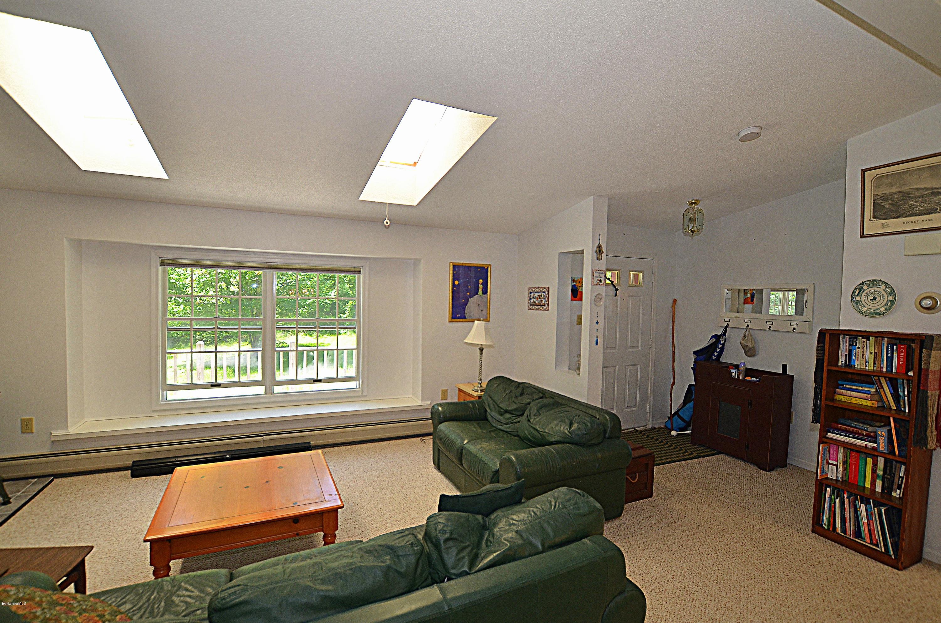 982 Fred Snow Road Becket, MA 01223 - Photo 5 of 21 a living room with furniture and a window