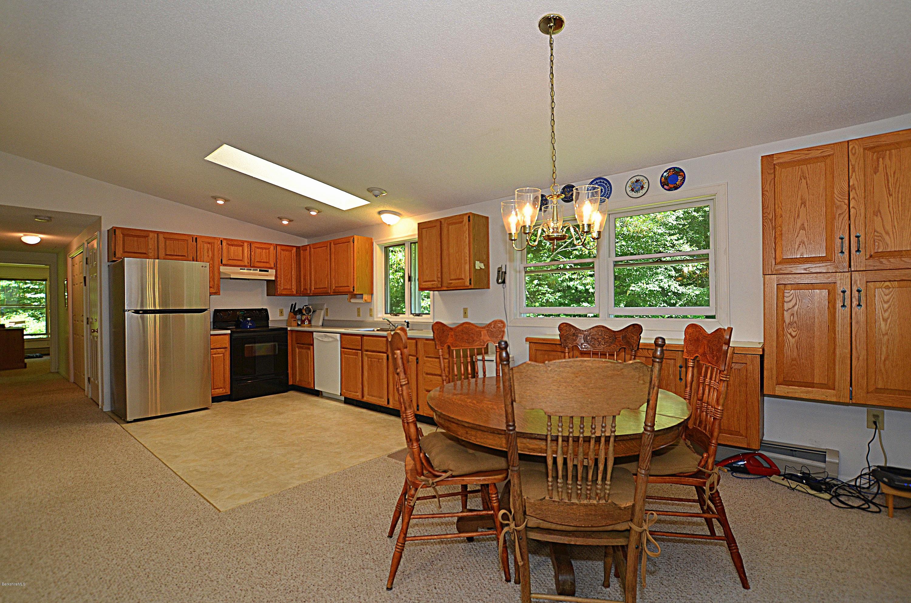 982 Fred Snow Road Becket, MA 01223 - Photo 7 of 21 a view of a dining room with furniture window and outside view