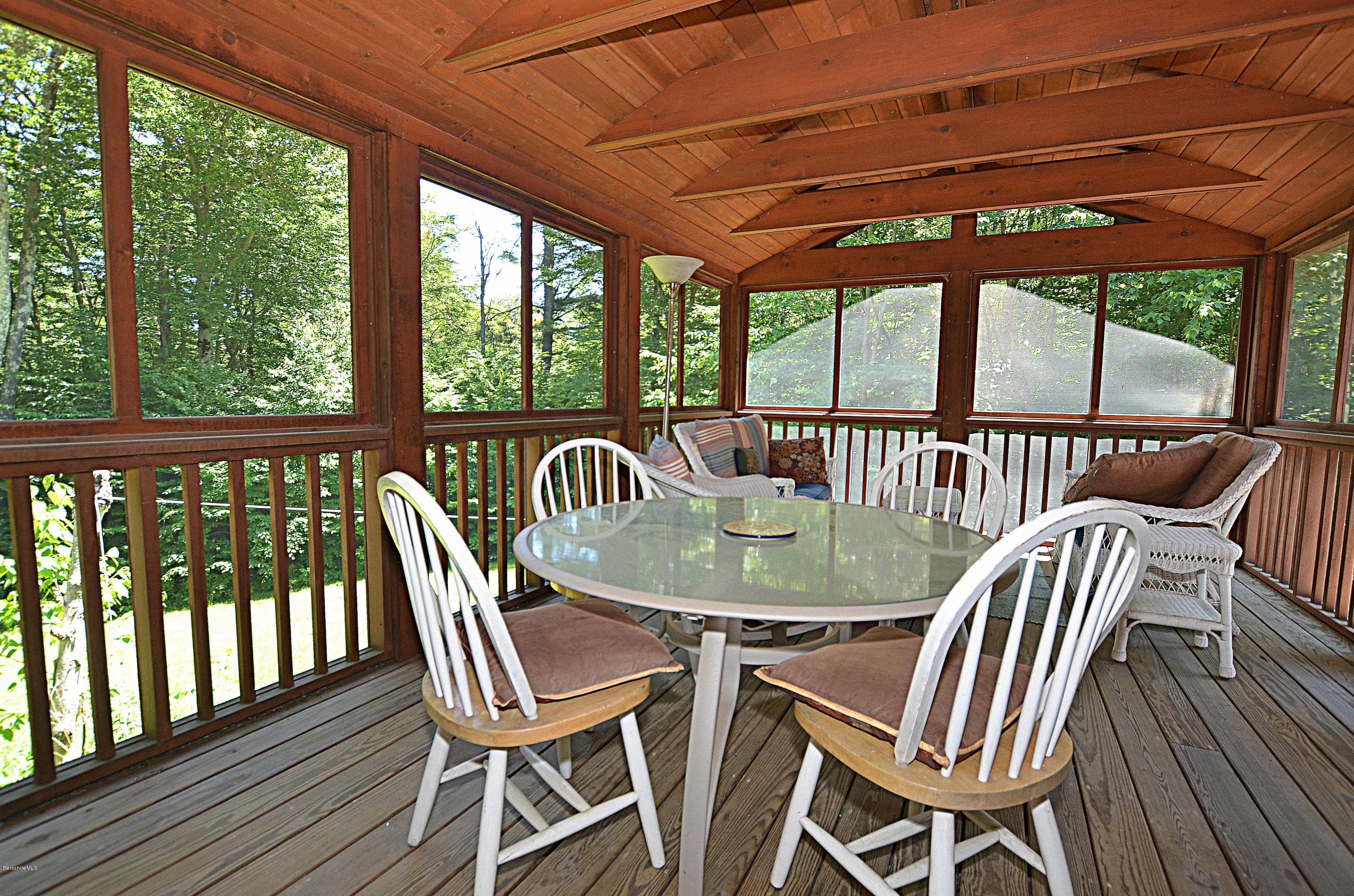982 Fred Snow Road Becket, MA 01223 - Photo 8 of 21 a view of a patio with table and chairs