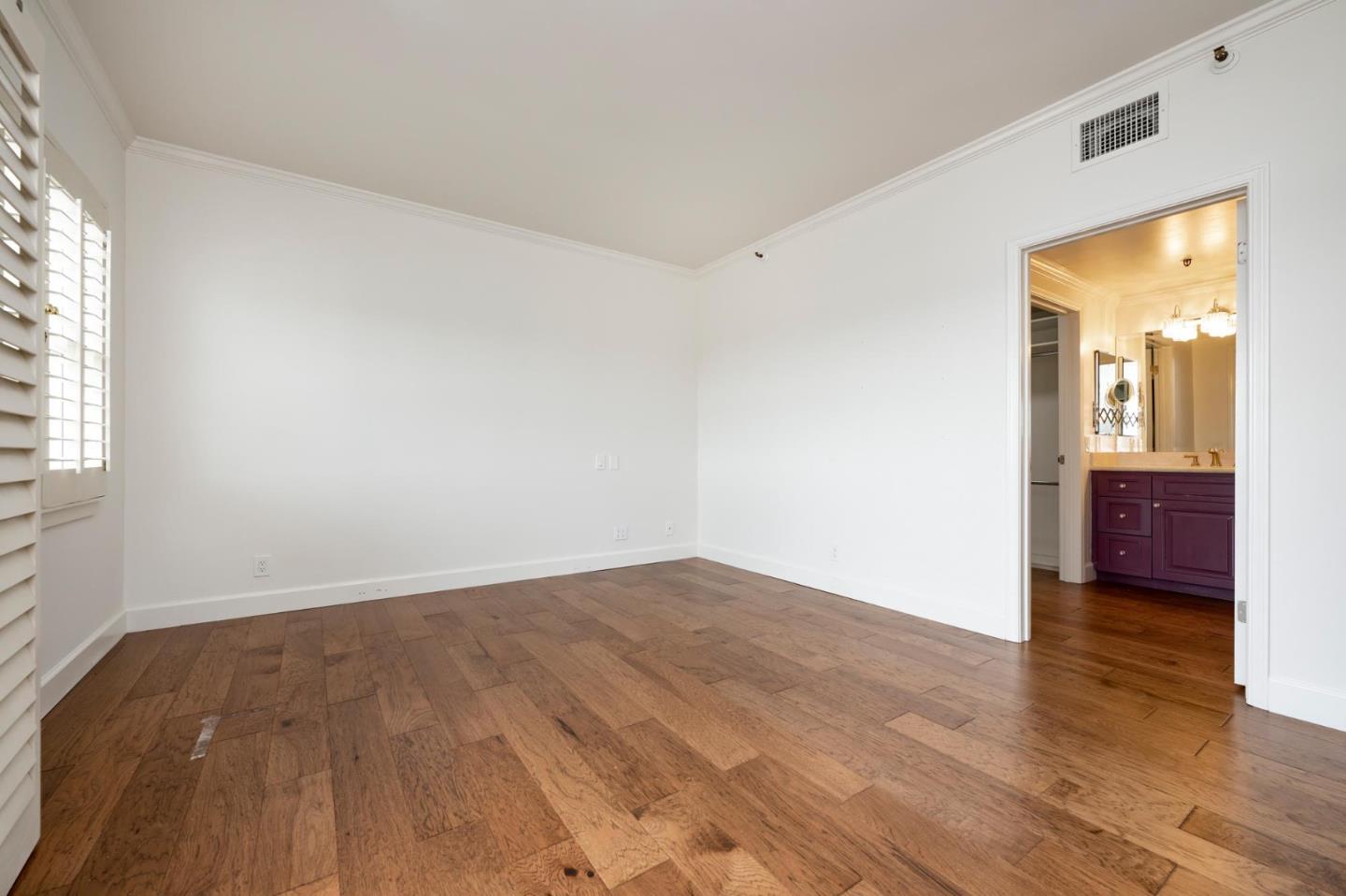 1 Baldwin Avenue, Unit 1017 San Mateo, CA 94401 - Photo 4 of 8 an empty room with wooden floor and windows