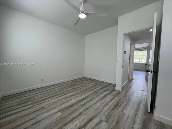 wooden floor in an empty room with a mirror