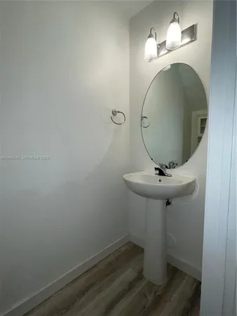 a bathroom with a sink and mirror