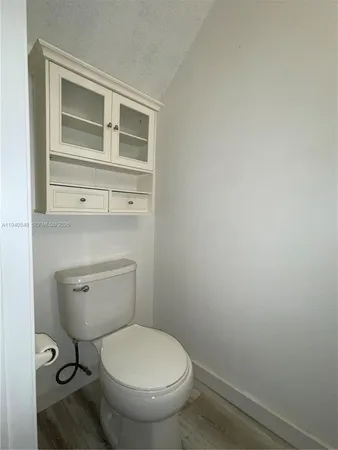 a white toilet sitting next to a bathroom sink