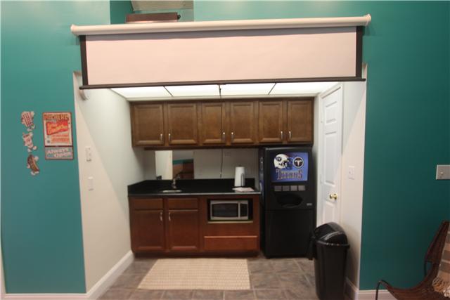 4311 Cairo Bend Road Lebanon, TN 37087 - Photo 12 of 20 Snack bar in media area with sink, microwave, refrigerator, cabinets & storage. Pull down screen for Media room projector. Popcorn and movies!