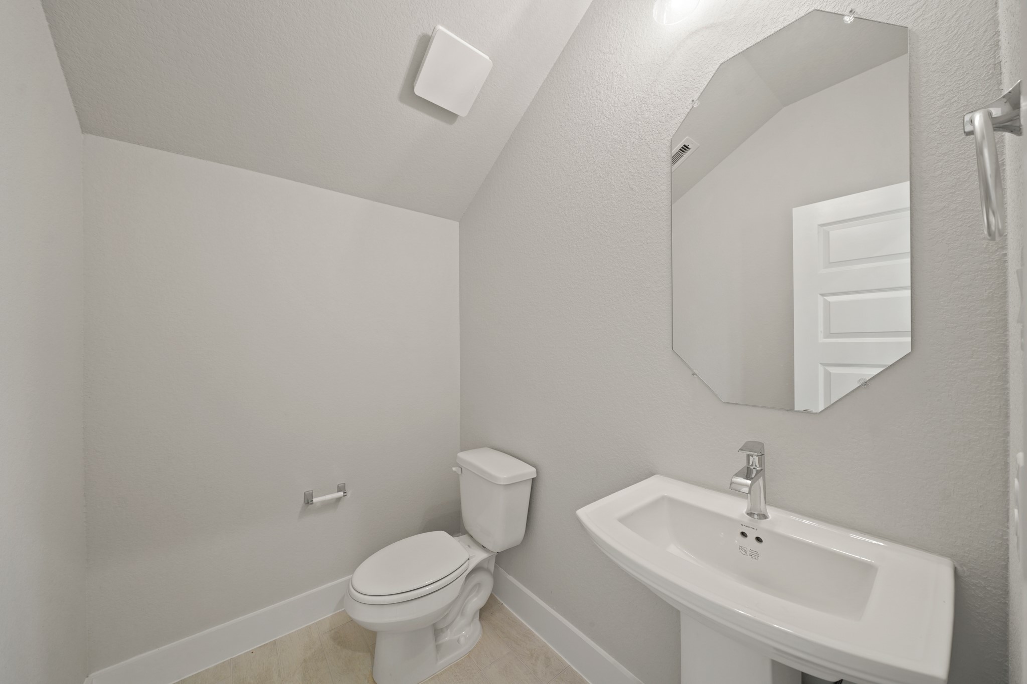 3319 Pin Cherry Lane Conroe, TX 77301 - Photo 13 of 30 a bathroom with a toilet a sink and mirror