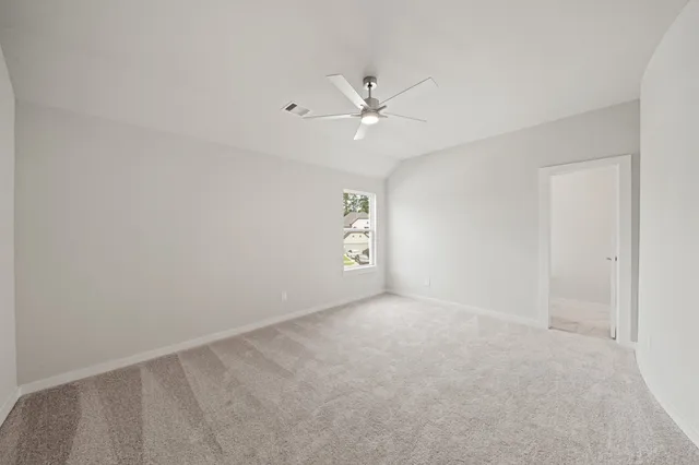 an empty room with fan and window
