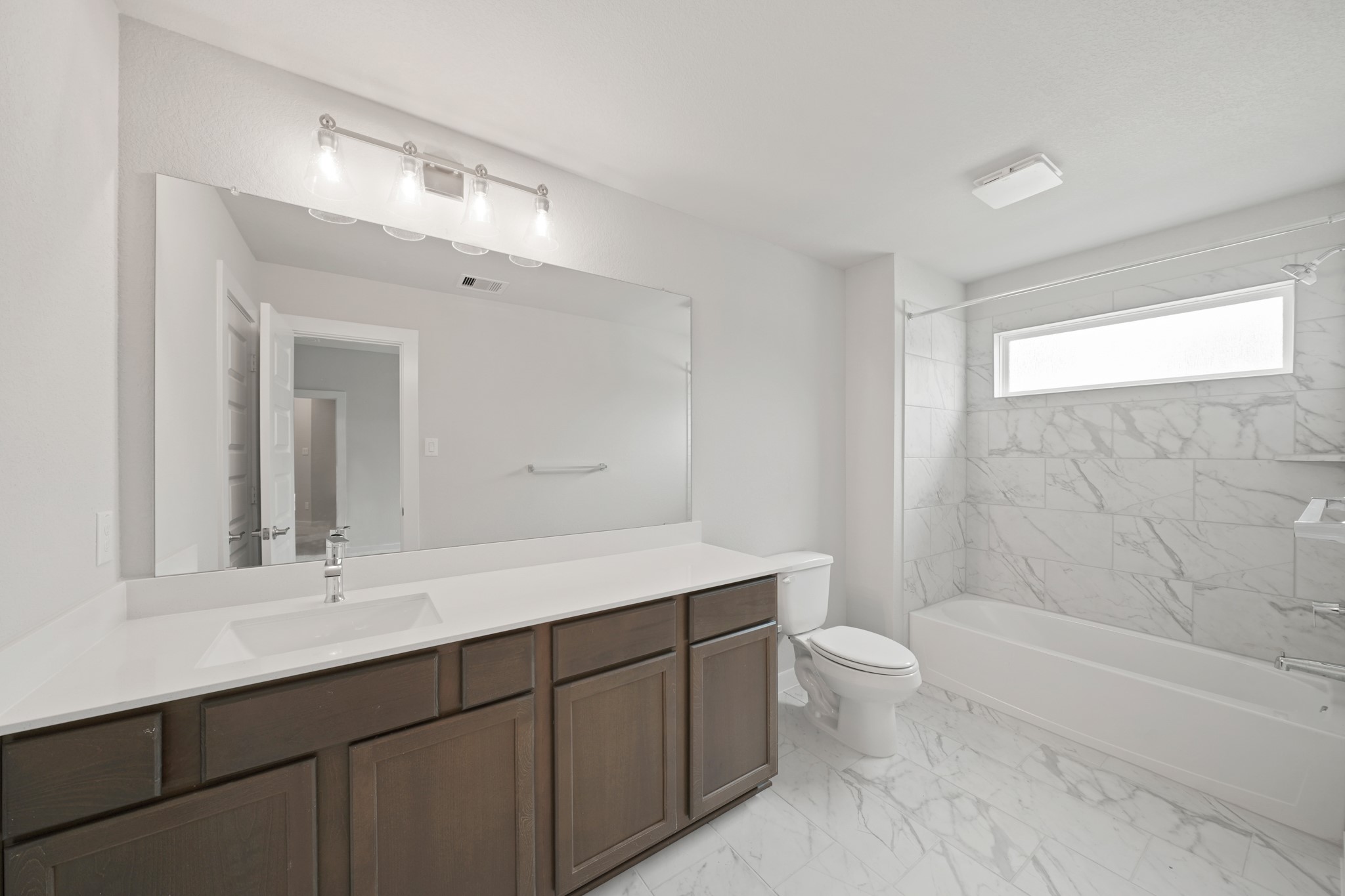 3319 Pin Cherry Lane Conroe, TX 77301 - Photo 26 of 30 a bathroom with a double vanity sink toilet mirror and bathtub