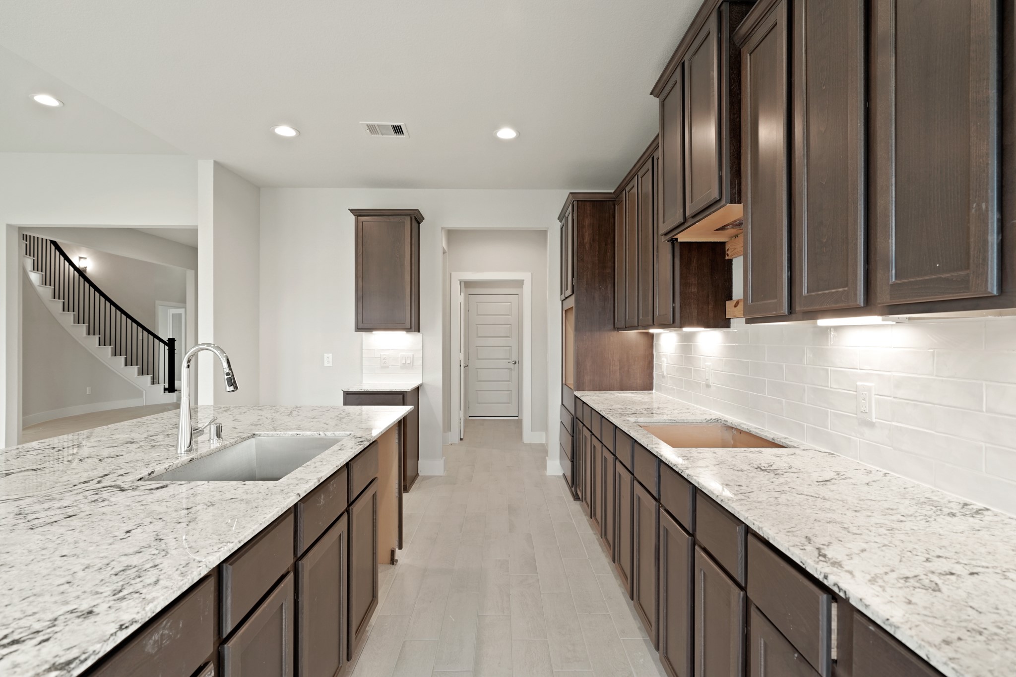 3319 Pin Cherry Lane Conroe, TX 77301 - Photo 7 of 30 a large kitchen with granite countertop a sink and cabinets