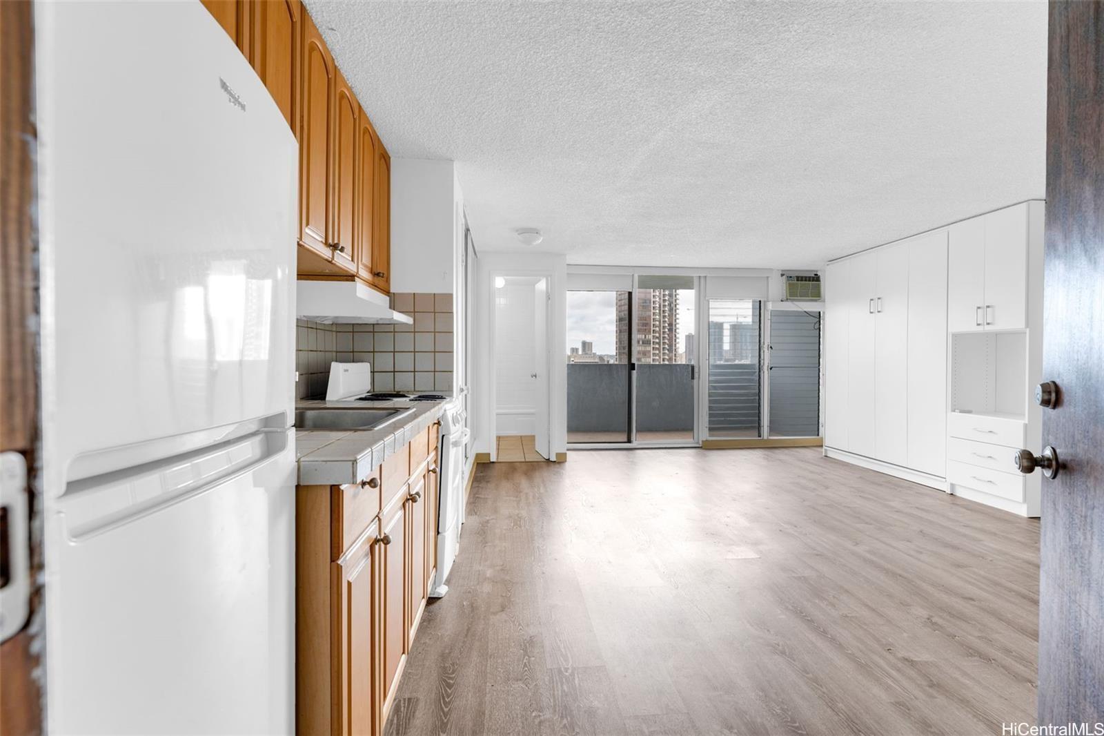 824 Kinau Street, Unit 809 Honolulu, HI 96813 - Photo 1 of 1 a view of a kitchen with a sink and refrigerator