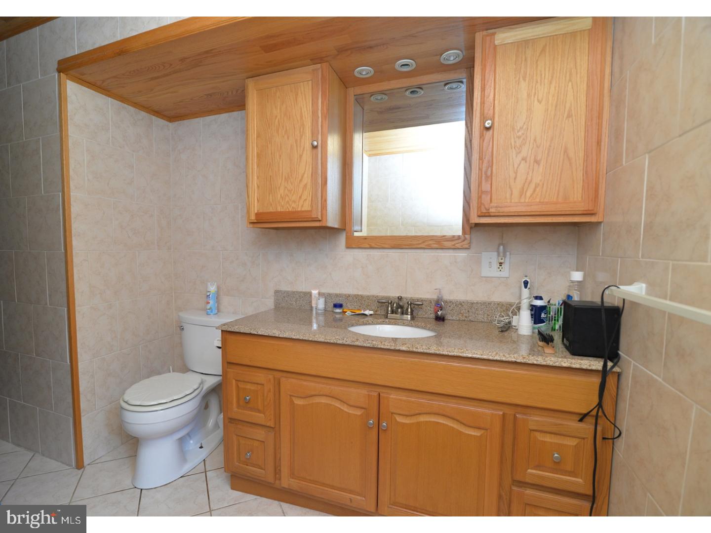 307 Germanville Road Ashland, PA 17921 - Photo 12 of 24 a bathroom with a granite countertop sink a toilet and a mirror