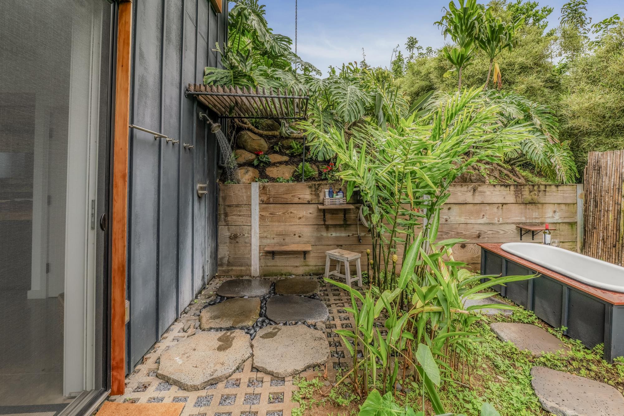 3127 Ua Noe Place, Unit B Haiku, HI 96708 - Photo 43 of 50 a backyard of a house with plants and outdoor seating
