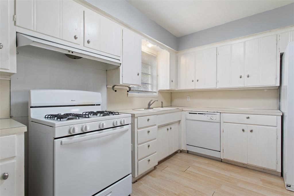 3126 Colgate Avenue Tyler, TX 75701 - Photo 6 of 33 a kitchen with cabinets appliances and a sink
