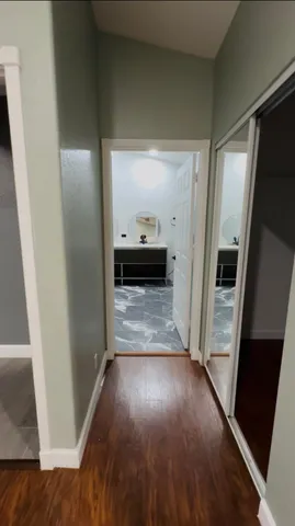 a view of a room with a ceiling fan and a window