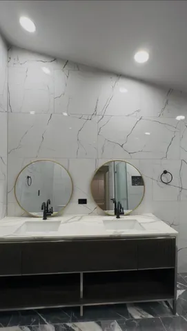 a large kitchen with kitchen island granite countertop a large counter top stainless steel appliances and cabinets