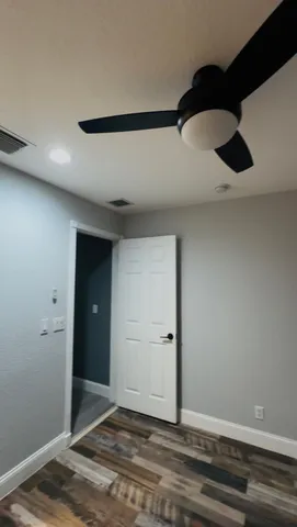 a view of a room with wooden floor