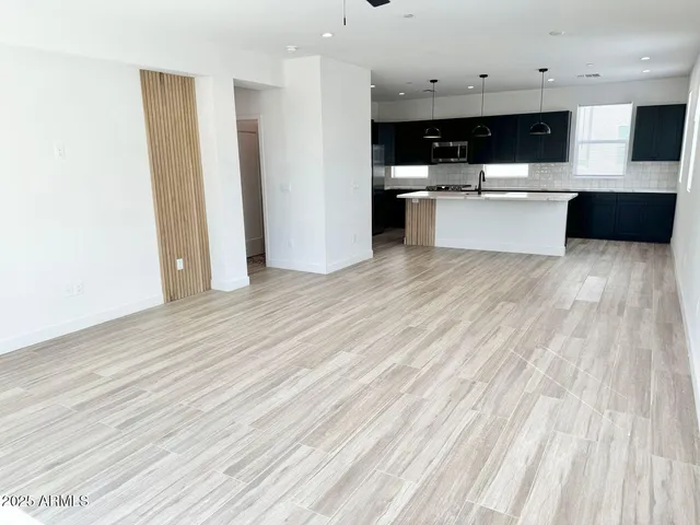 a view of kitchen with cabinets microwave and stove