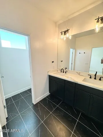 a bathroom with a double vanity sink mirror and shower