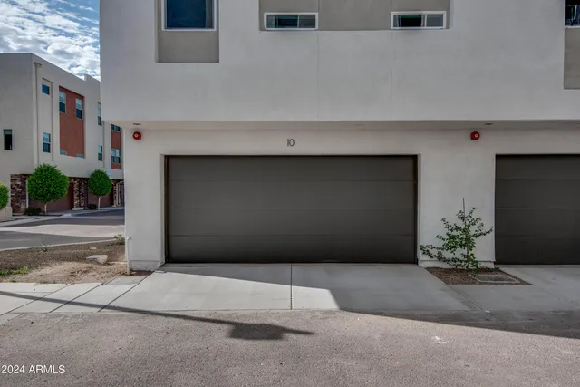 an empty room with a ceiling fan and window