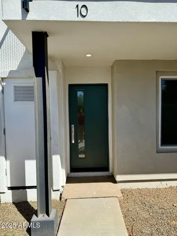 a view of bathroom with a sink and mirror