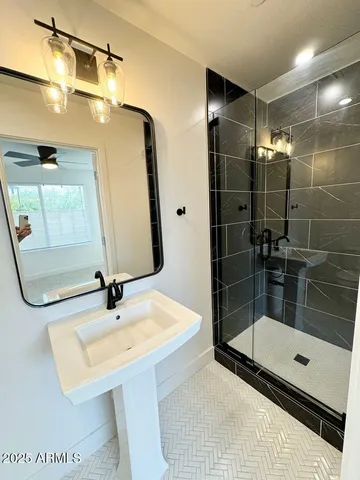 a bathroom with a sink a toilet and mirror