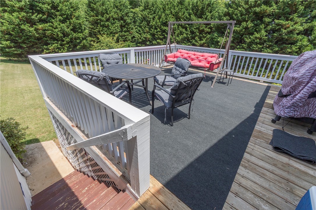861 North Old Pendleton Road Liberty, SC 29657 - Photo 35 of 45 A spacious outdoor deck with wood flooring and white railings, offering ample space for entertaining and relaxation.