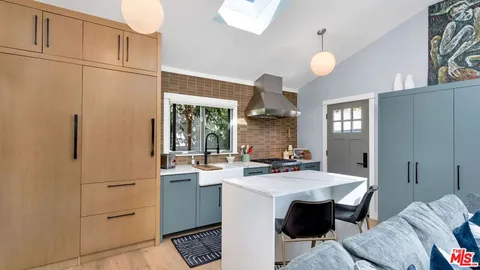 a kitchen with a sink cabinets and appliances