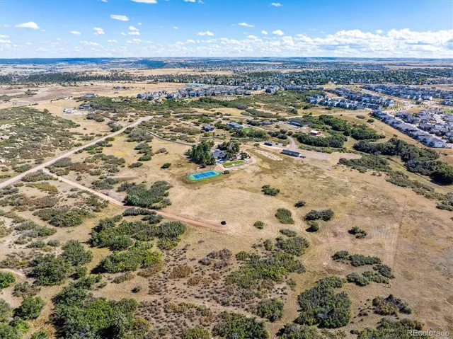 an aerial view of residential building and ocean view in back