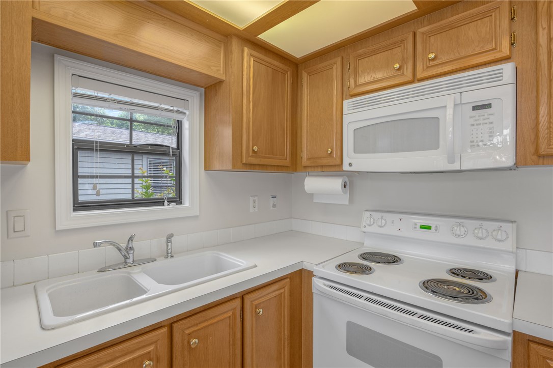 1230 Melton Road, Unit 25 West Union, SC 29696 - Photo 33 of 46 A well-lit kitchen with natural wood cabinetry and essential appliances for everyday cooking.