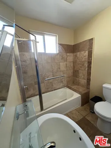 a bathroom with a bathtub and a shower