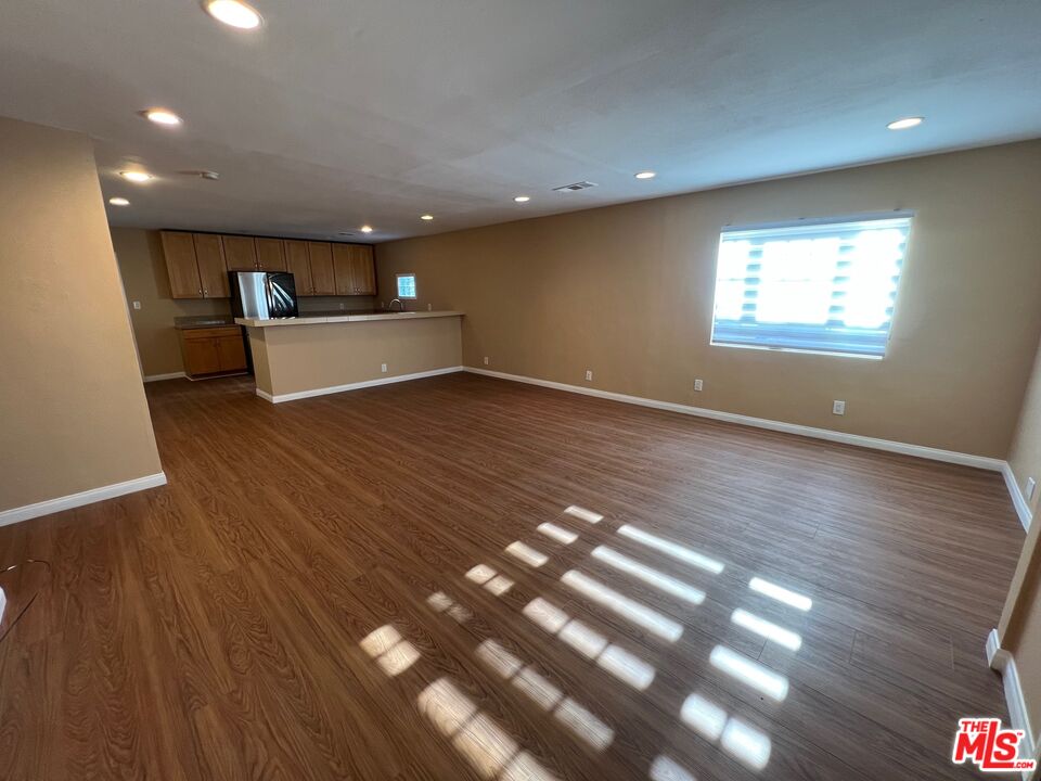 17844 Hartland Street Reseda, CA 91335 - Photo 3 of 18 a view of a room with wooden floor and window