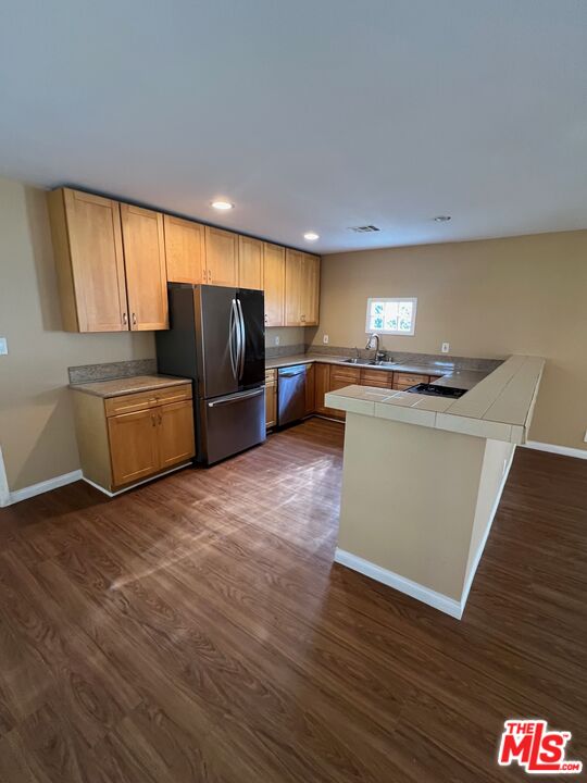 17844 Hartland Street Reseda, CA 91335 - Photo 5 of 18 a kitchen with stainless steel appliances a microwave a stove a refrigerator and cabinets