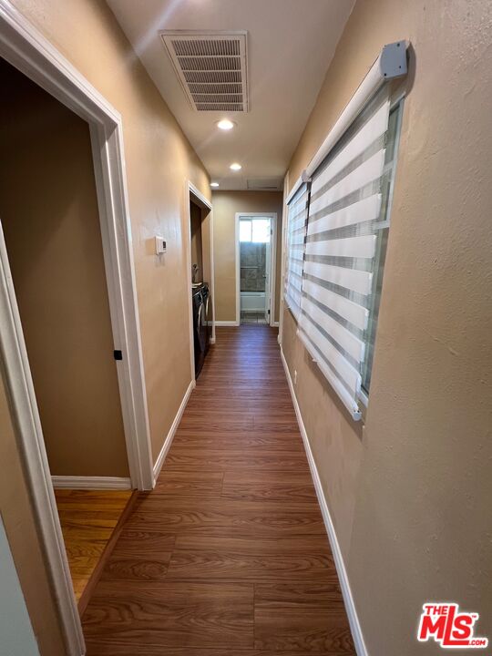 17844 Hartland Street Reseda, CA 91335 - Photo 7 of 18 a view of a hallway with wooden floor and stairs