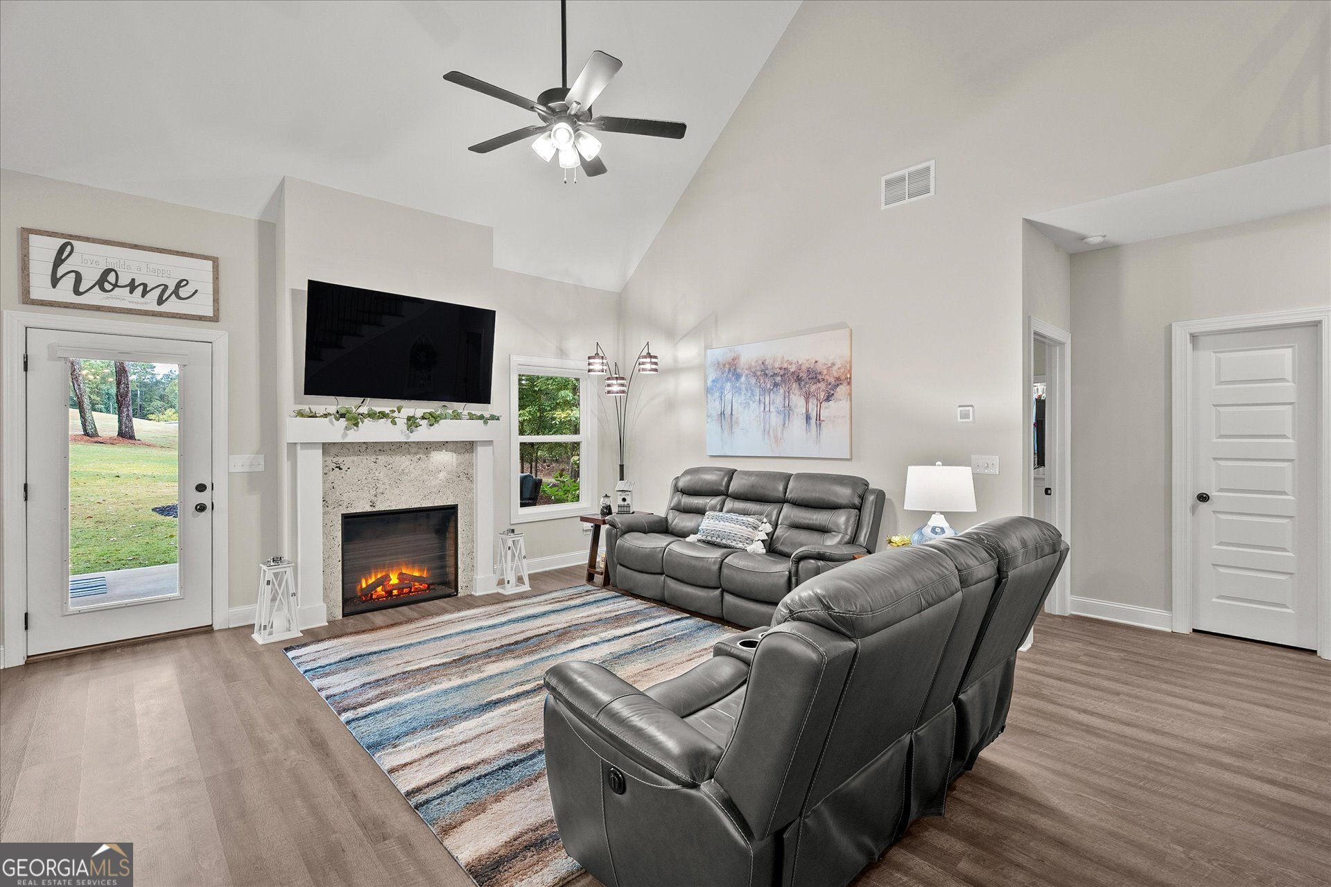 3260 Greenhill Court Villa Rica, GA 30180 - Photo 11 of 80 a living room with furniture a flat screen tv and a fireplace