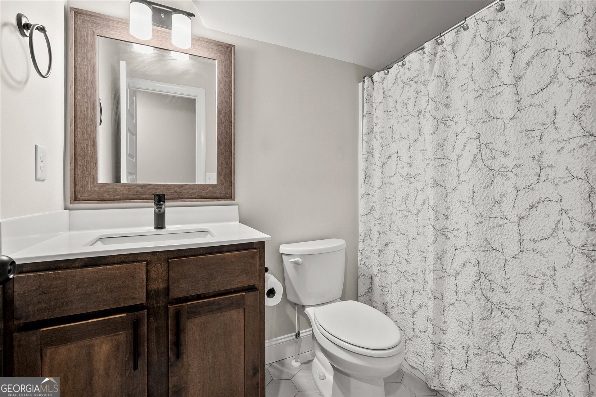3260 Greenhill Court Villa Rica, GA 30180 - Photo 41 of 80 a bathroom with a granite countertop toilet sink and mirror