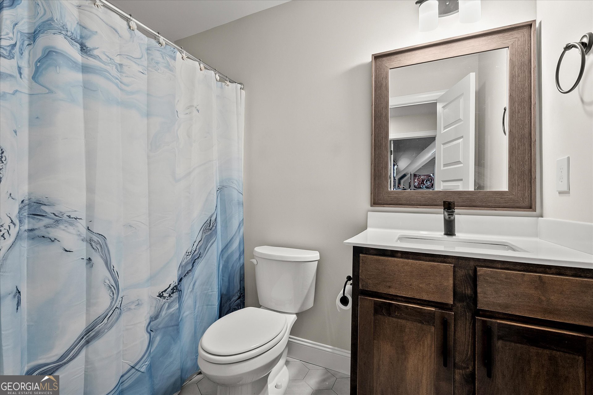 3260 Greenhill Court Villa Rica, GA 30180 - Photo 44 of 80 a bathroom with a toilet a sink and a mirror