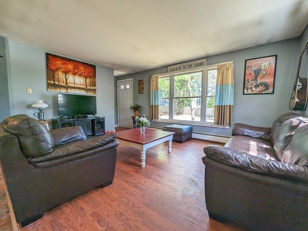 30 Cohasset Road Buzzards Bay, MA 02532 - Photo 12 of 24 a living room with fireplace furniture and a flat screen tv