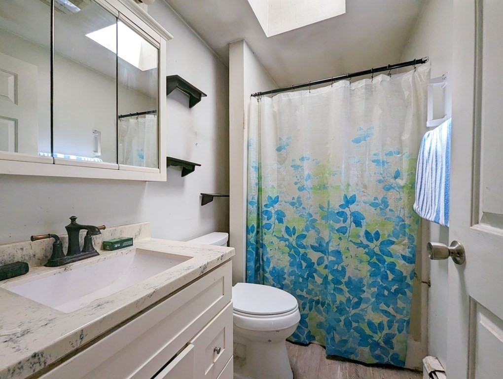 30 Cohasset Road Buzzards Bay, MA 02532 - Photo 13 of 24 a bathroom with a sink a toilet and shower curtain