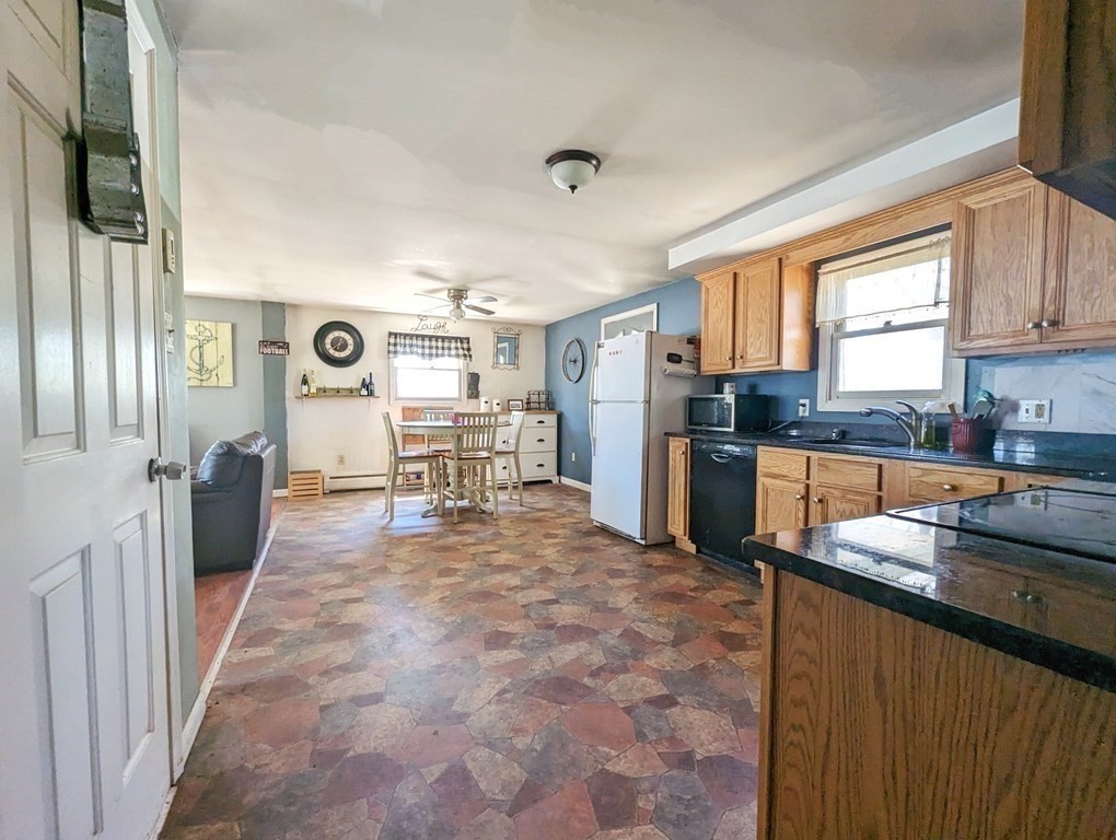 30 Cohasset Road Buzzards Bay, MA 02532 - Photo 8 of 24 a kitchen with granite countertop a refrigerator and a stove top oven