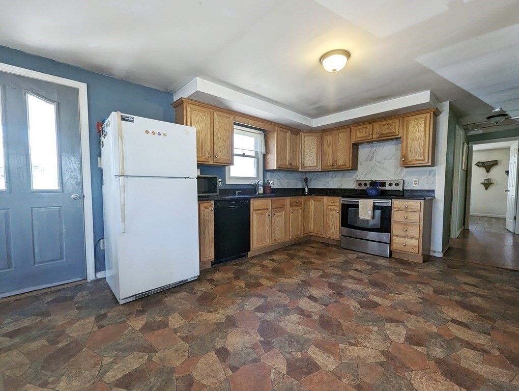 30 Cohasset Road Buzzards Bay, MA 02532 - Photo 9 of 24 a kitchen with a refrigerator and a stove top oven