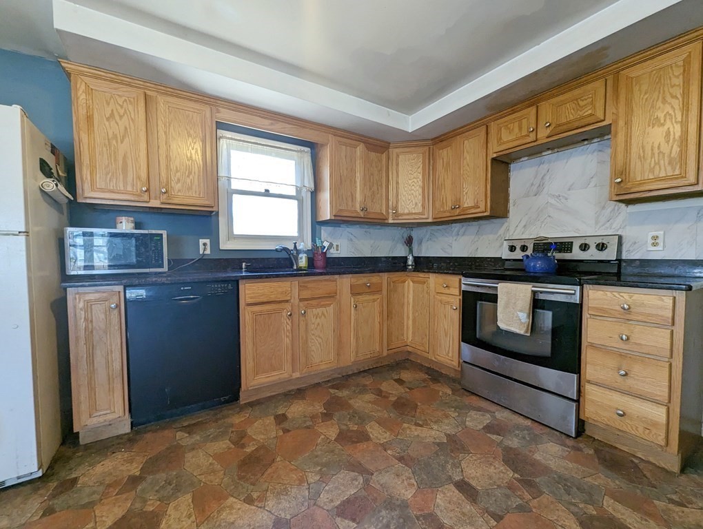 30 Cohasset Road Buzzards Bay, MA 02532 - Photo 10 of 24 a kitchen with granite countertop a stove sink and cabinets